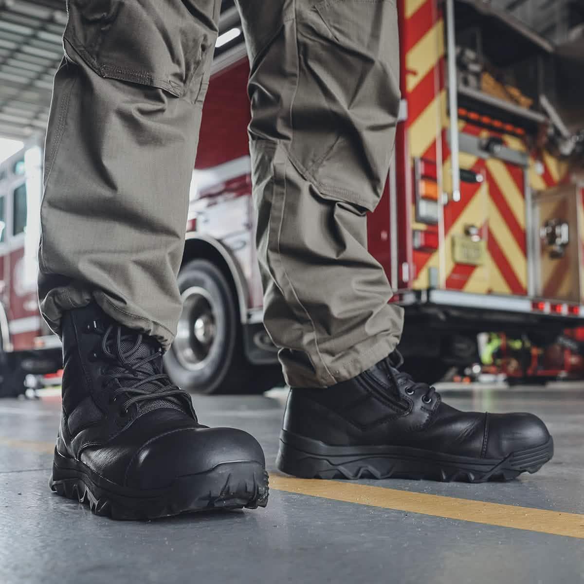 GORUCK rugged black tactical boots and cargo pants in front of a fire truck in a garage.
