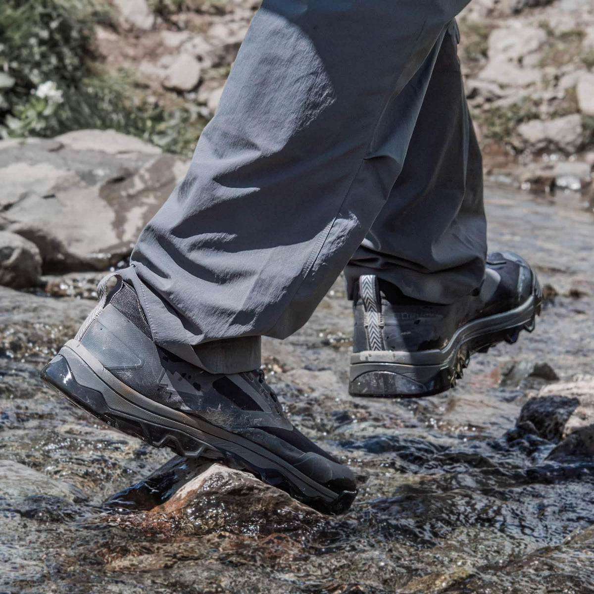 GORUCK rucking shoes in action crossing a rocky stream, outdoor adventure gear