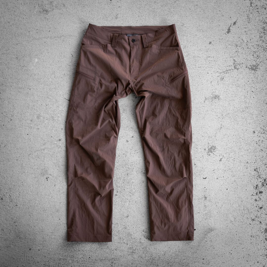 Abrasion-resistant brown utility pants with side zipper pockets.