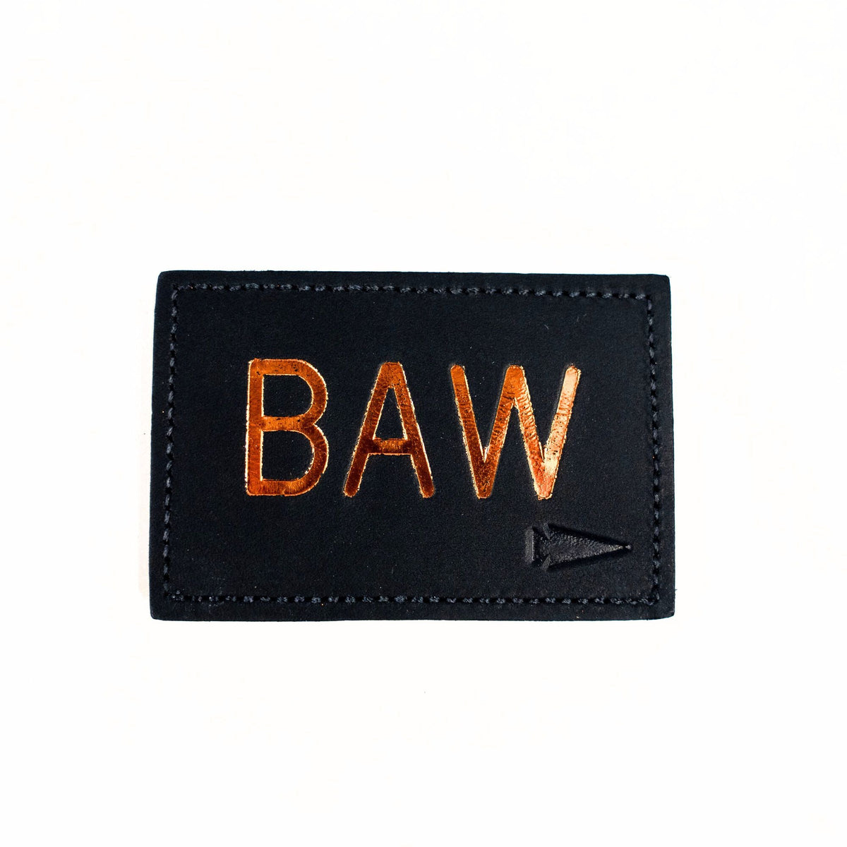 The Patch - Custom Leather Monogram features a black leather patch with shiny gold "BAW" letters and a small gold arrow, making it a unique personalized gift, shown on a crisp white background.