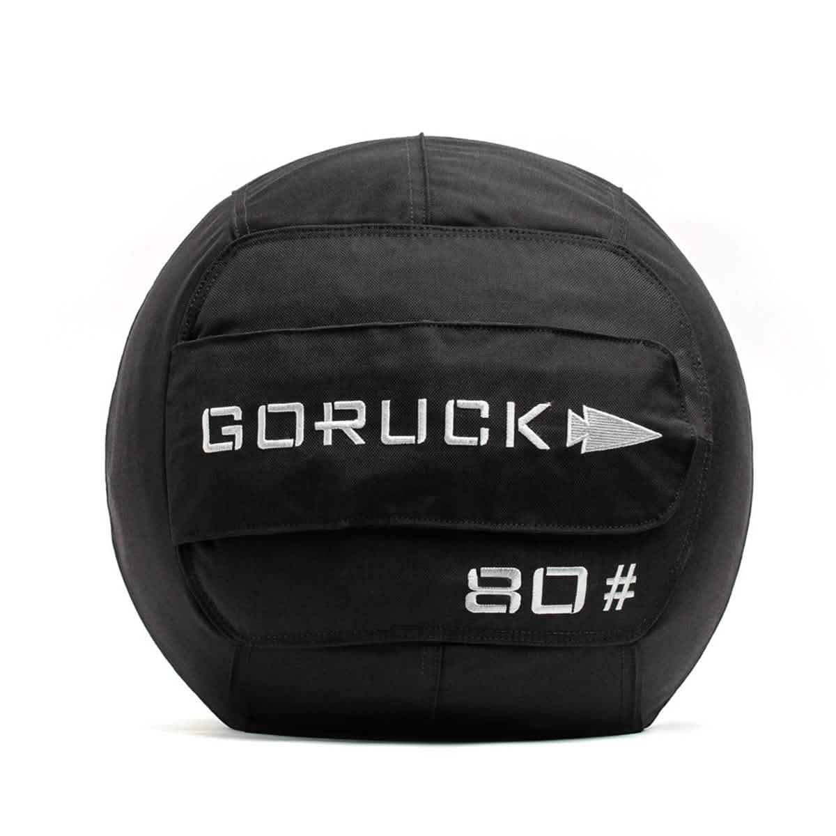 A black Sand Medicine Ball by GORUCK, featuring a handle, is perfect for boosting core stability at home. The ball is marked with the brand name GORUCK and the number 80 in white text, making it a versatile piece of equipment for your home gym collection.