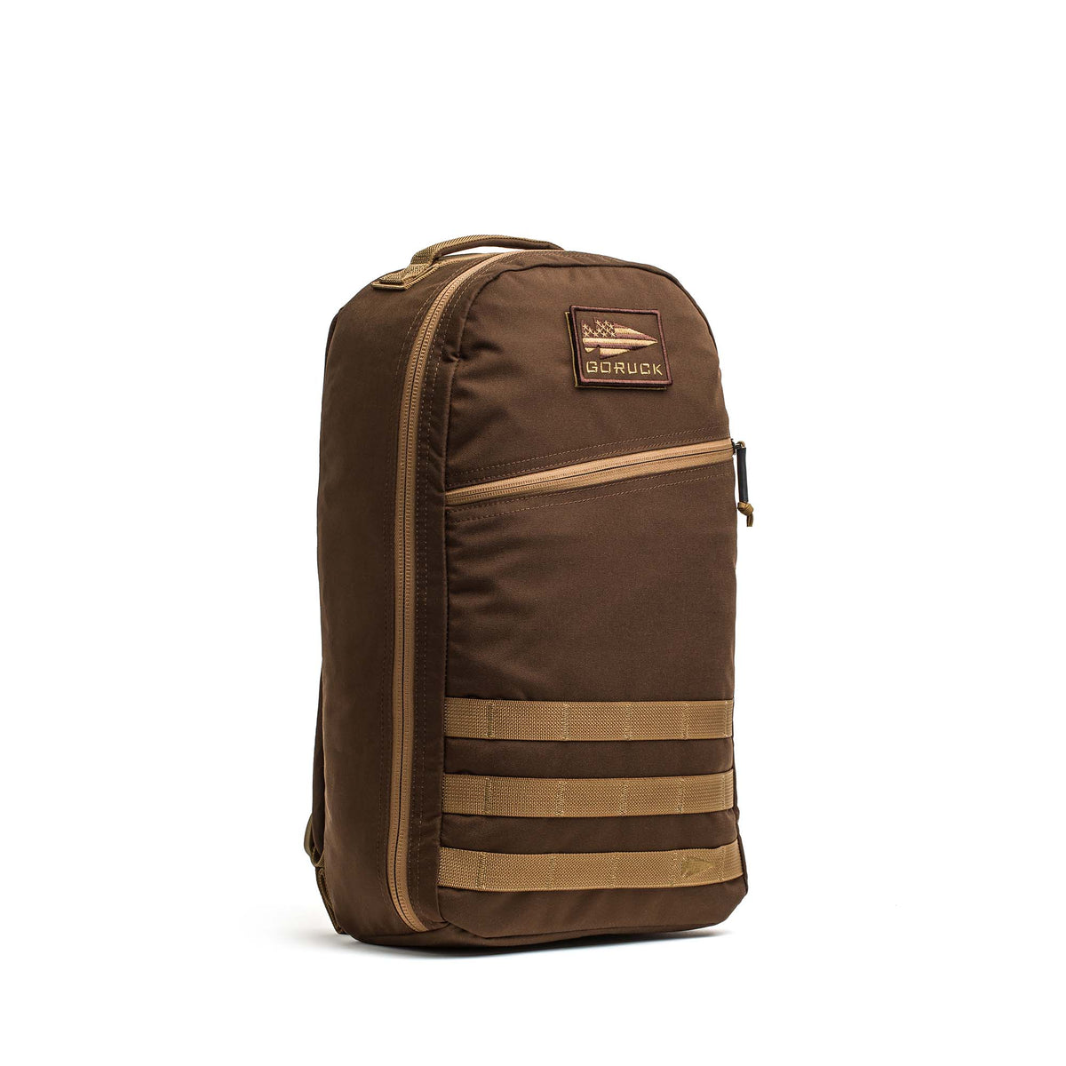 The Bullet Ruck Classic - Ballistic Nylon Cordura is a brown 15L daypack with a front patch, top handle, and tan horizontal straps for a sleek backpack look against a white background.