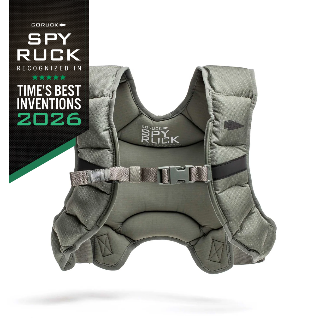 A grey GORUCK Spy Ruck weight vest with a chest buckle, accompanied by a black banner labeling it as one of Time’s Best Inventions of 2026.