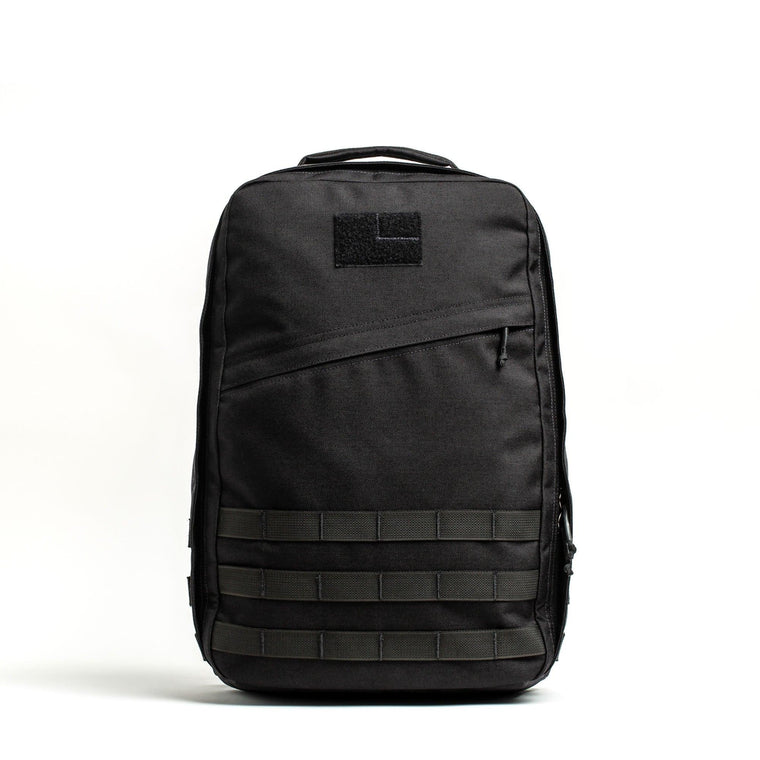 GORUCK GR1 21L black rucksack with MOLLE webbing, shown on white background