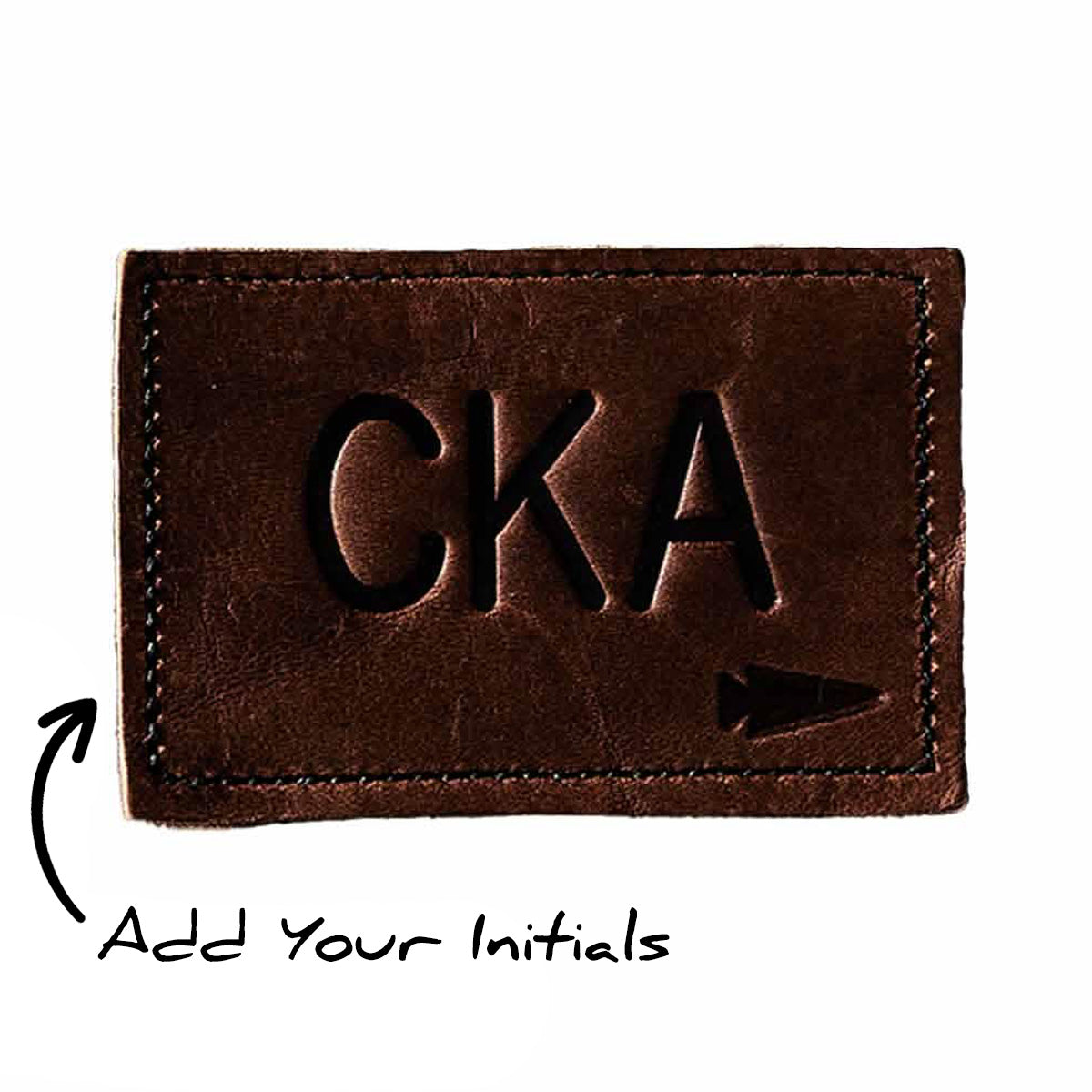 Customizable brown leather patch, embossed with "CKA" and an arrow icon. Personalize with the text "Add Your Initials" and an arrow. Product: Patch - Custom Leather Monogram.