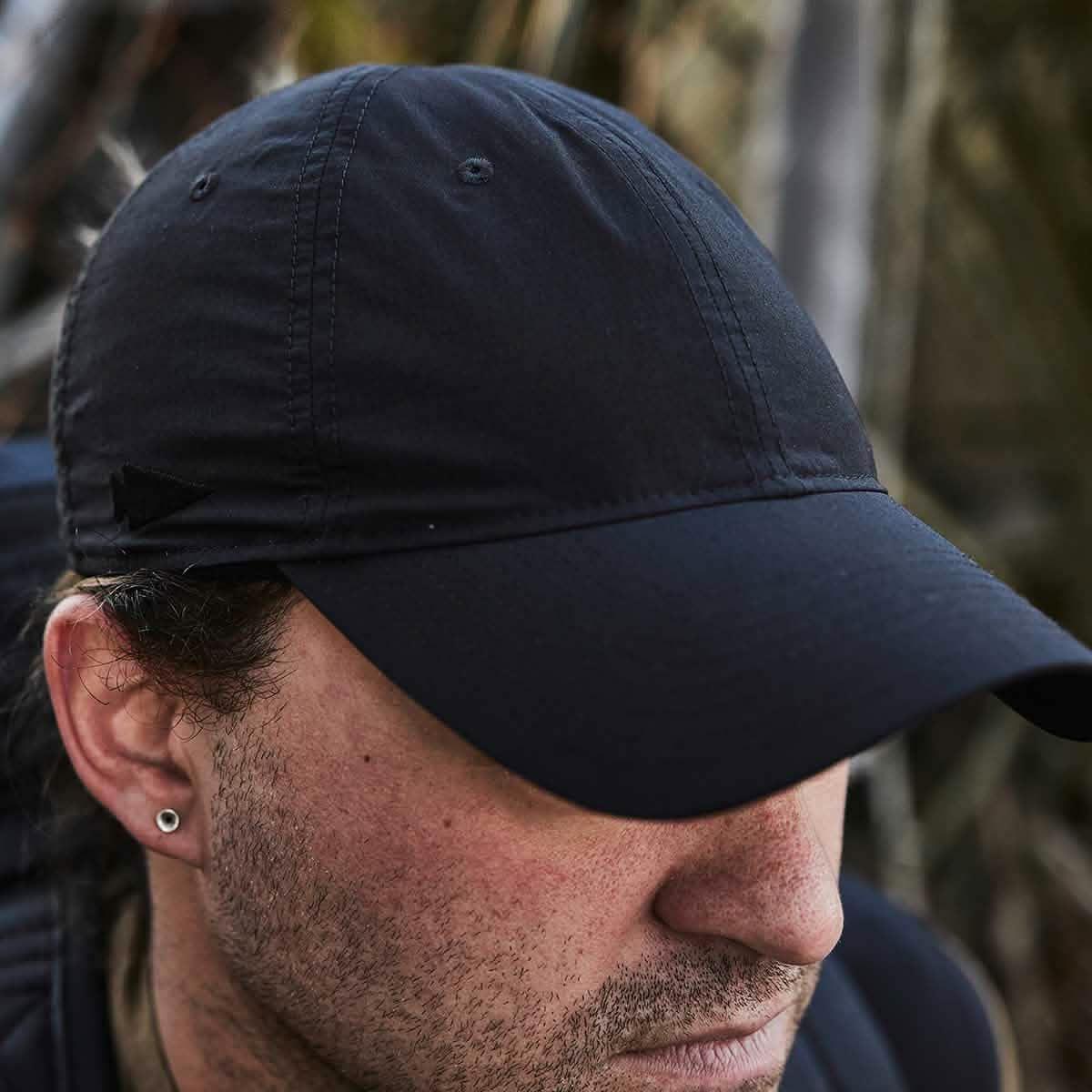 GORUCK black performance rucking cap worn outdoors by a person with an earring