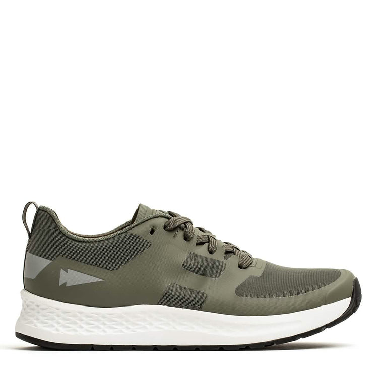Introducing the Rough Runner - Earth athletic shoe by GORUCK: a sleek green design featuring a white textured sole and black accents. This lace-up style includes reflective arrow details and is crafted with lightweight, breathable mesh fabric. The Gradient Density midsole ensures a comfortable fit for any adventure.