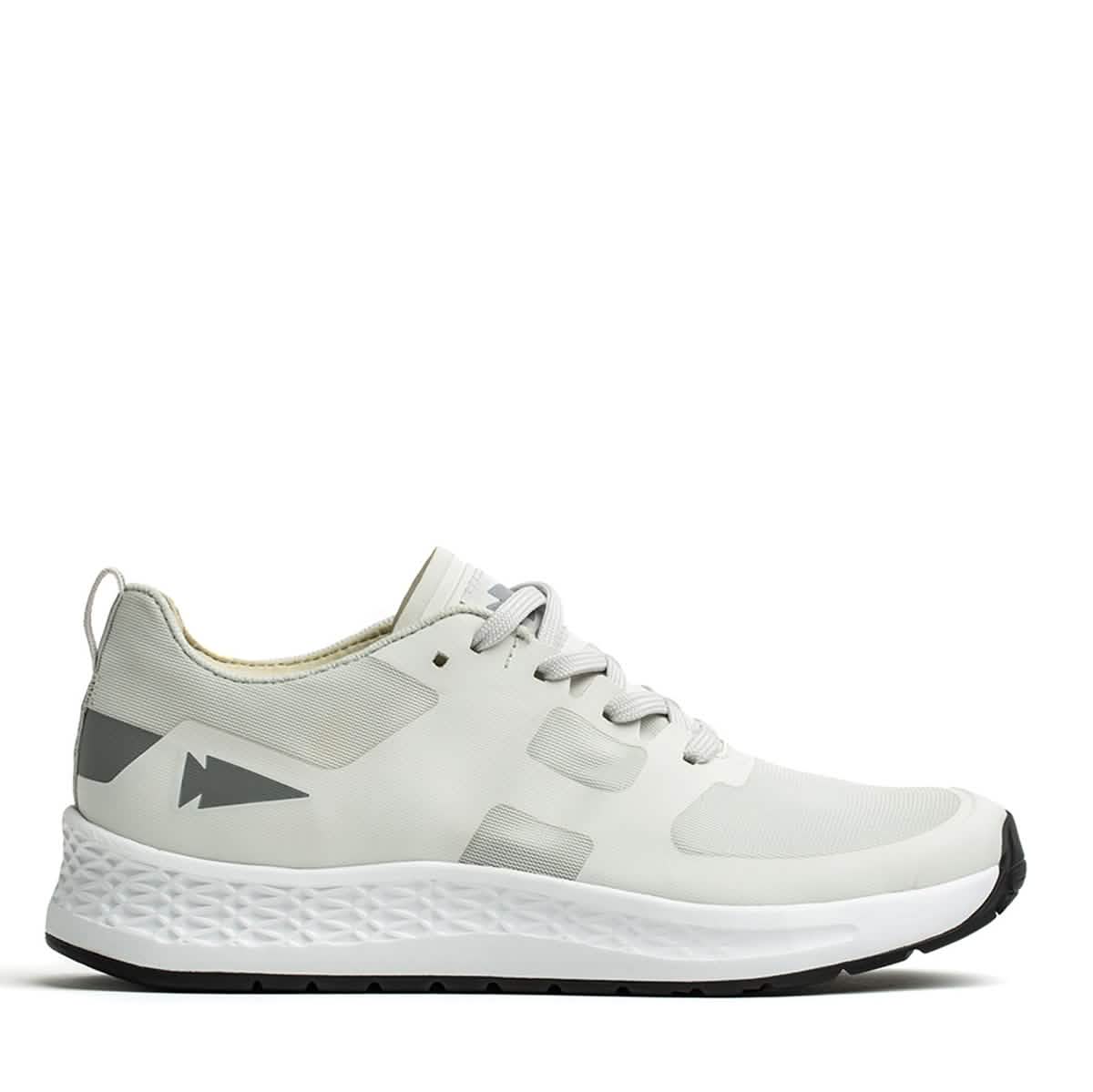 Introducing the GORUCK Rough Runner - Light Grey + Dark Grey: This athletic shoe boasts a sleek, performance-enhancing design with gradient density. It features light gray accents on the heel adorned with an arrow-like graphic, while the textured white midsole seamlessly pairs with a black outer sole. Gray laces are threaded through ingeniously designed channels for added style and functionality.