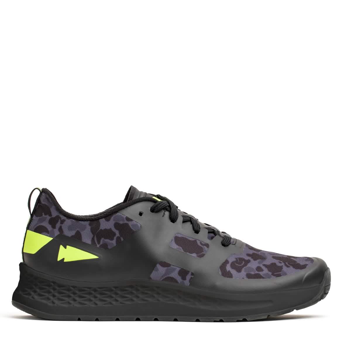Introducing the Rough Runner - Midnight Frogskin + Acid Lime by GORUCK: a sleek black sneaker with a subtle leopard print, accented with neon yellow details and equipped with black laces. Featuring Gradient Density™ for ultimate comfort, it boasts a convenient pull tab at the back and a textured sole for superior traction.