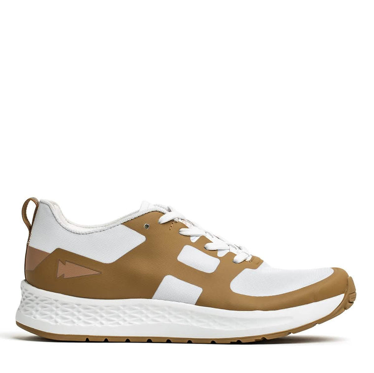 The Rough Runner - Speed Tan by GORUCK features a sleek design with a textured sole and lace-up style. It includes white and brown colors, geometric patterns on the side, and a pull tab at the heel. Its gradient density makes it perfect for casual outings as well as high-mileage athletic activities.
