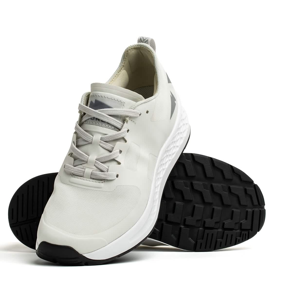 The GORUCK Rough Runner - Light Grey + Dark Grey is featured against a pristine white background. This athletic shoe highlights its textured sole with gradient density and is positioned to emphasize both the top design and the tread pattern beneath.